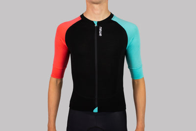 cyclist wearing merino cycle jersey in Coral Egg & Jet front view